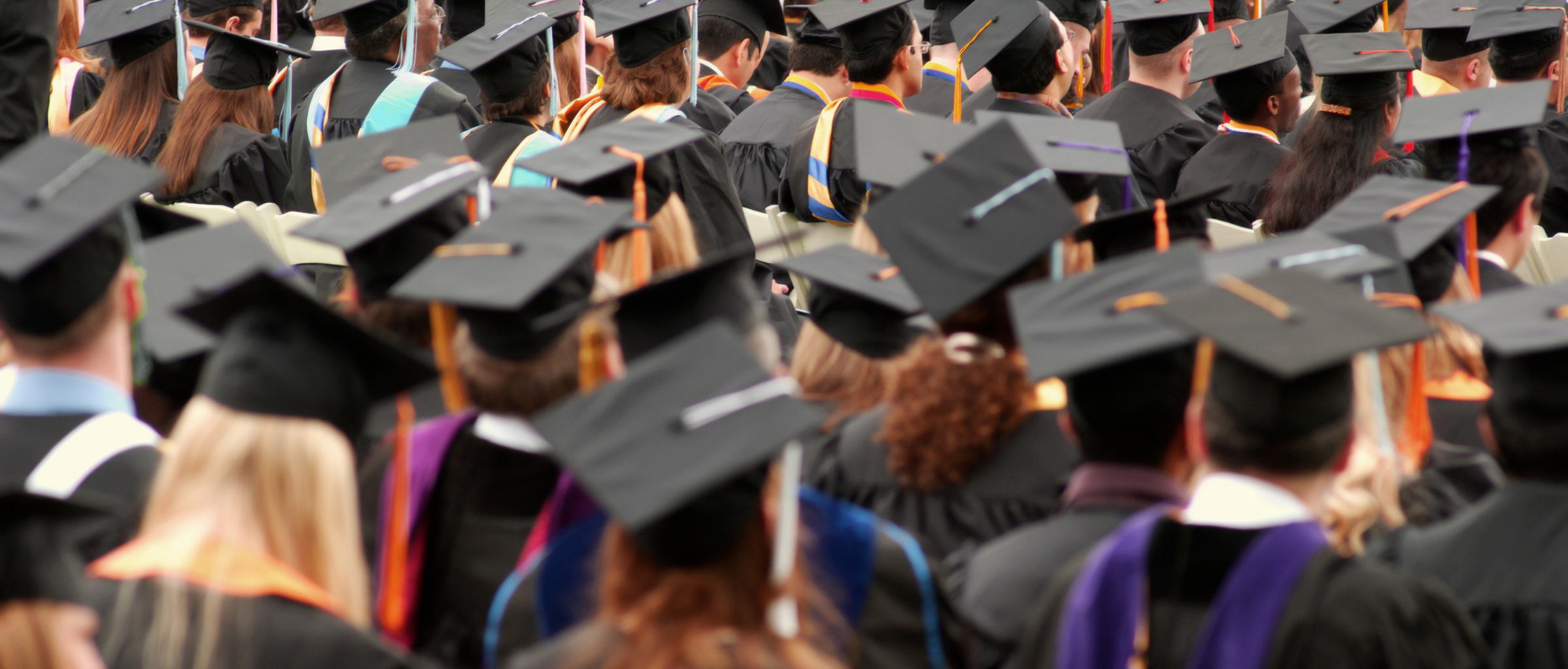 Large group of people wearing graduation caps and gowns